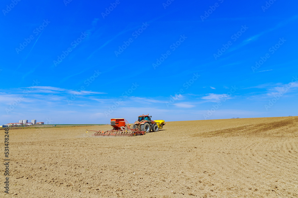 The drill is attached to the tractor, sows the field with grain. Modern technology works in the field. The drill is attached to the tractor, sows the field with grain. Modern technology works in the field.