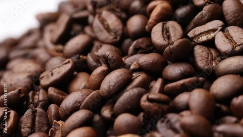 Coffee beans close up. Rotation of roasted coffee beans close-up.