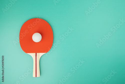 ping pong racket and ball on green background photo