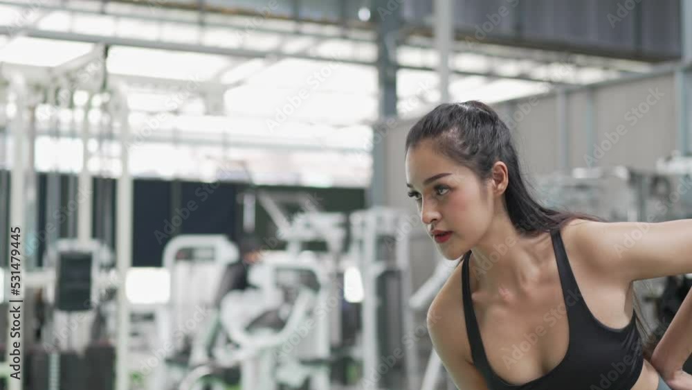 Healthy Asian athlete woman do workout exercise body weight lifting at fitness gym.