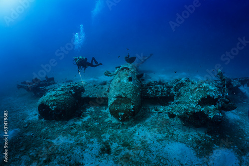 Cuadro en lienzo A scuba diver explores a sunken world war two fighter propeller airplane at the