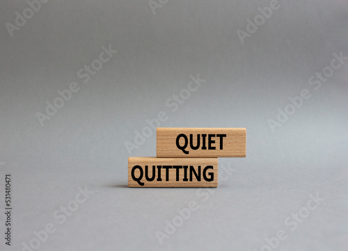 Quiet quitting symbol. Concept word Quiet quitting on wooden blocks. Beautiful grey background. Business and Quiet quitting concept. Copy space.