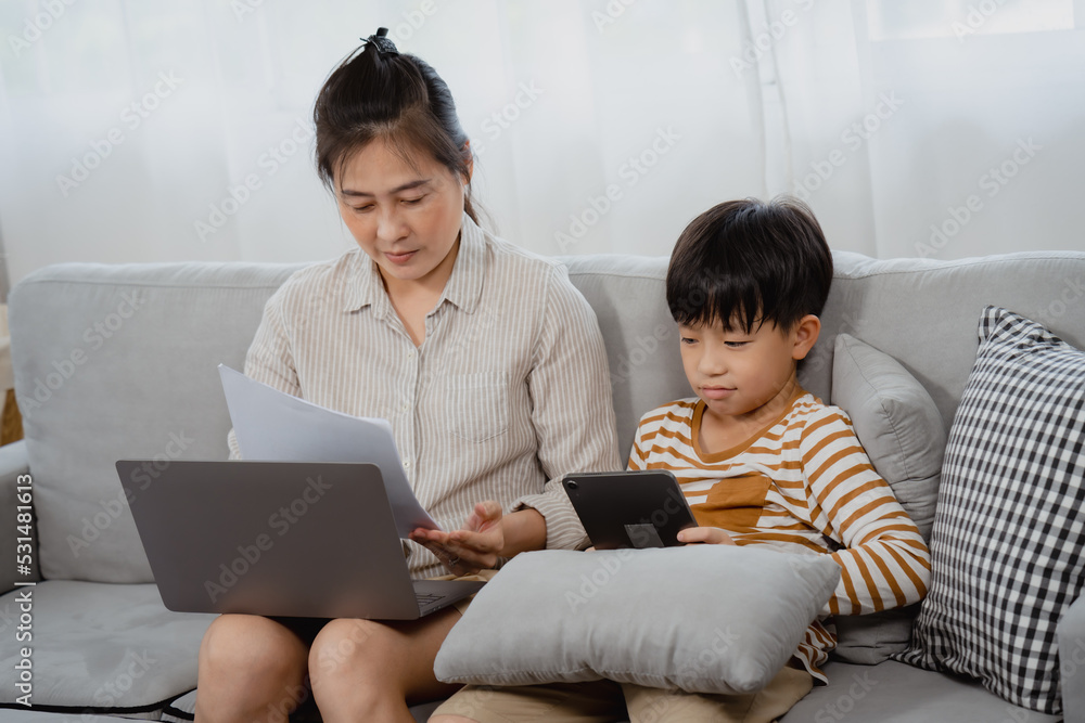 Handsome Asian boy, And his mother is working on a laptop computer, The little boy annoyed and nervously pulled the paper out of his mother's hand, wanting her to play with herself. Handsome Asian boy, And his mother is working on a laptop computer, The little boy annoyed and nervously pulled the paper out of his mother's hand, wanting her to play with herself.