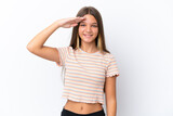 Little caucasian girl isolated on white background saluting with hand with happy expression