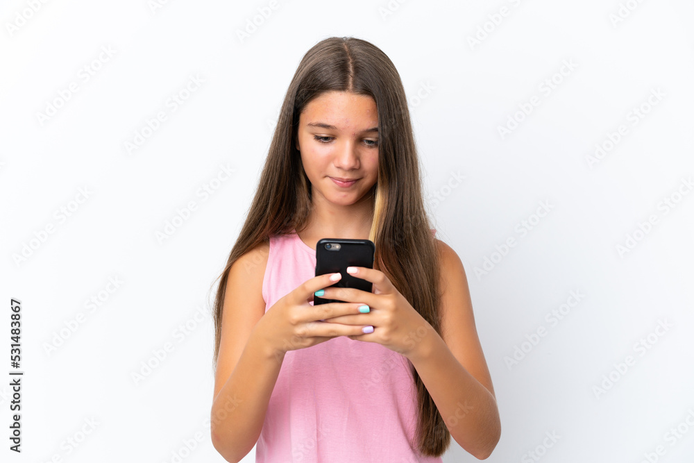 Little caucasian girl isolated on white background sending a message with the mobile Little caucasian girl isolated on white background sending a message with the mobile
