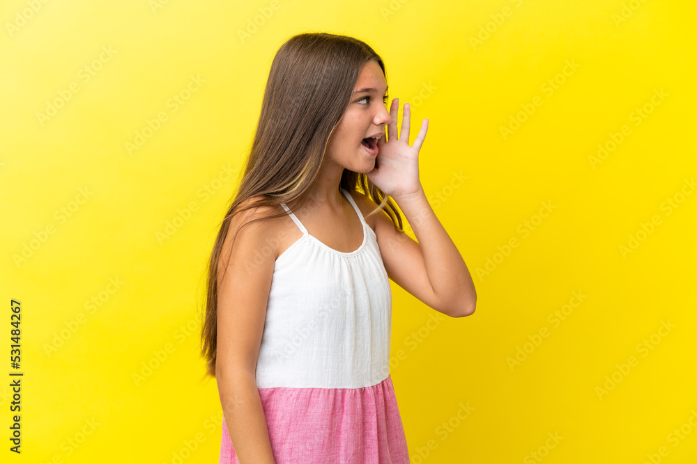 Little caucasian girl isolated on yellow background shouting with mouth wide open to the side Little caucasian girl isolated on yellow background shouting with mouth wide open to the side