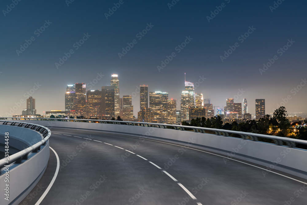 Naklejka premium Empty urban asphalt road exterior with city buildings background. New modern highway concrete construction. Concept of way to success. Transportation logistic industry fast delivery. Los Angeles. USA.