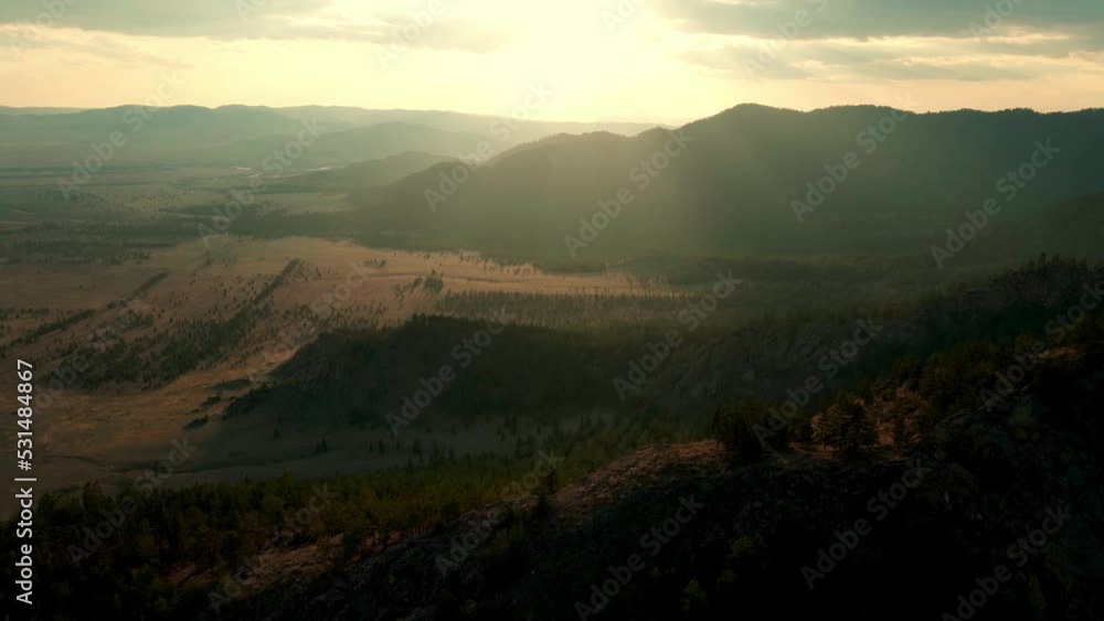aerial view of hilly valley, flight over wooded hills during sunset aerial view of hilly valley, flight over wooded hills during sunset