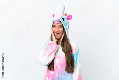 Little caucasian girl wearing unicorn pajama isolated on white background with surprise and shocked facial expression