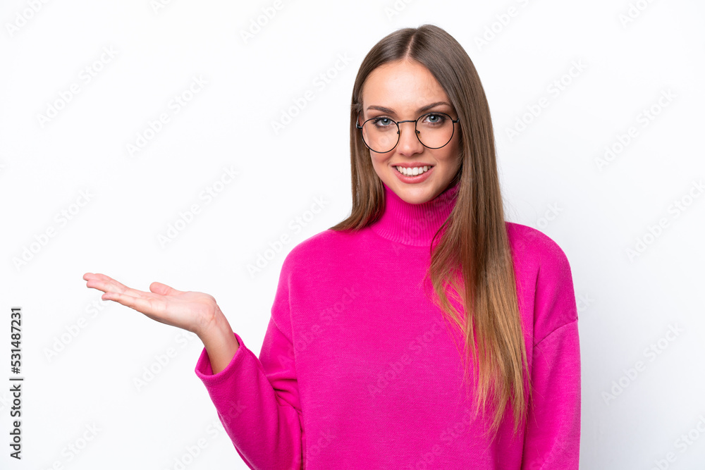 Young caucasian woman isolated on white background holding copyspace imaginary on the palm to insert an ad Young caucasian woman isolated on white background holding copyspace imaginary on the palm to insert an ad