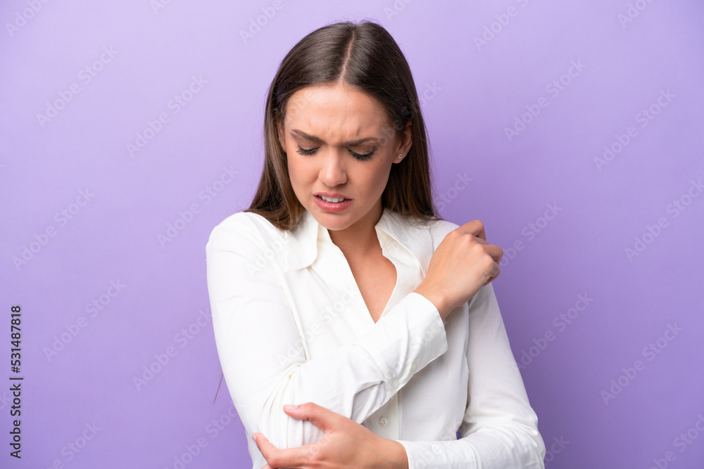 Young caucasian woman isolated on purple background with pain in elbow Young caucasian woman isolated on purple background with pain in elbow