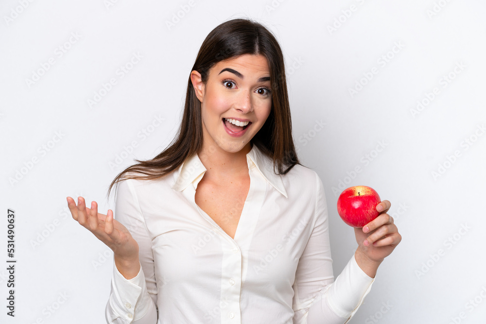 Young Brazilian woman with an apple isolated on white background with shocked facial expression Young Brazilian woman with an apple isolated on white background with shocked facial expression