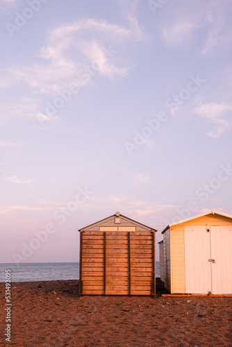 Beach Huts On Teignmouth's Back Beach At Sunset