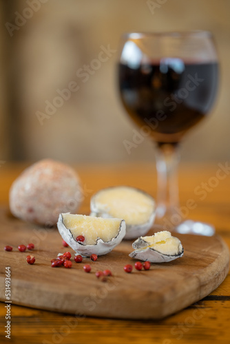 Belper knole balls with garlic and pink pepper in wood ash. A glass of red wine. Swiss cheese. Lactic fermented cheese. SDOF photo