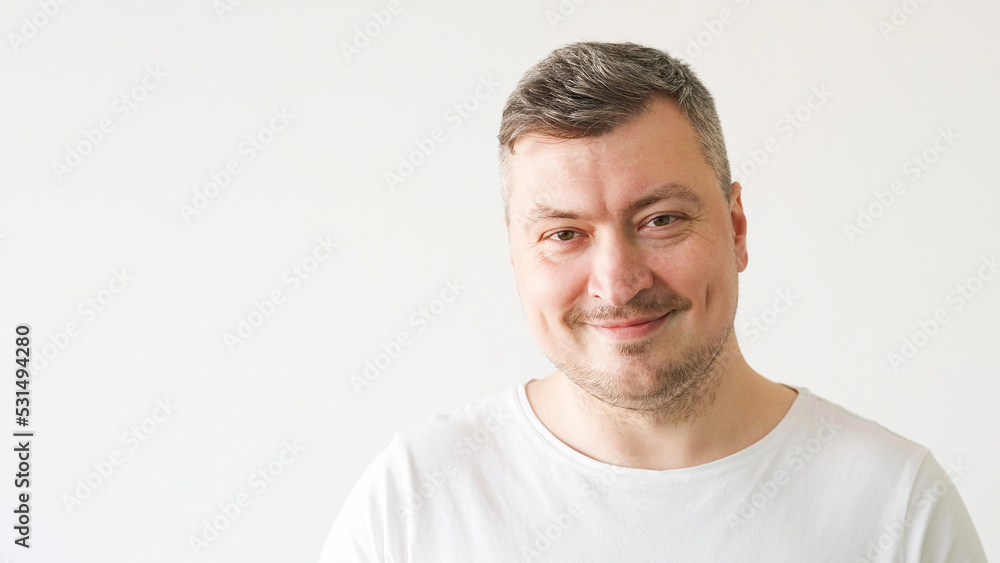 Positive man. Good morning. Enjoying moment. Handsome satisfied smiling guy in white t-shirt on light background. Positive man. Good morning. Enjoying moment. Handsome satisfied smiling guy in white t-shirt on light background.