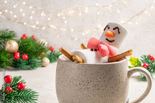 Mug with hot chocolate with melted marshmallow snowman. Merry Christmas drink. Happy Holiday card