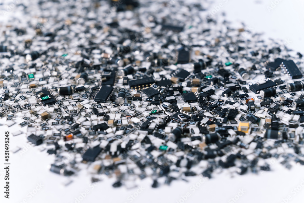 Various electrical components for circuit board mixed and scattered on white surface. Silver and black. Technology. Horizontal shot. High quality photo Various electrical components for circuit board mixed and scattered on white surface. Silver and black. Technology. Horizontal shot. High quality photo