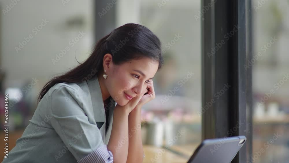 Beautiful woman watching entertainment things in tablet with happy and giggle face. Beautiful woman watching entertainment things in tablet with happy and giggle face.
