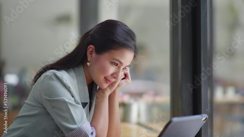 Beautiful woman watching entertainment things in tablet with happy and giggle face.