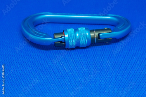 Lightweight aluminium carabiners on a blue background. Strong connectors for climbing close-up