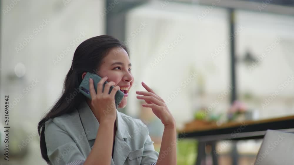 Young business women working and talking on a phone calling with happy and smile face on office space. Young business women working and talking on a phone calling with happy and smile face on office space.