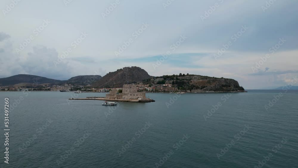 Aerial view of castle on an island in the sea of Greece, near the town of Nafplio. Former capital of Greece, Drone flyover blue water, ancient fort Aerial view of castle on an island in the sea of Greece, near the town of Nafplio. Former capital of Greece, Drone flyover blue water, ancient fort