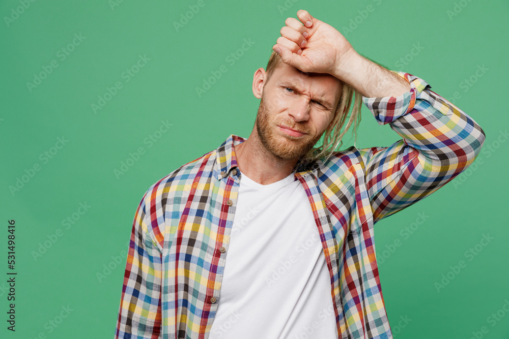Young caucasian blond man with dreadlocks he wear casual shirt put hand on head forehead suffer from headache isolated on pastel plain light green background studio portrait. People lifestyle concept. Young caucasian blond man with dreadlocks he wear casual shirt put hand on head forehead suffer from headache isolated on pastel plain light green background studio portrait. People lifestyle concept.