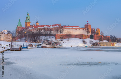 Krakow snowy winter, evening Wawel Castle over Vistula river, Poland
