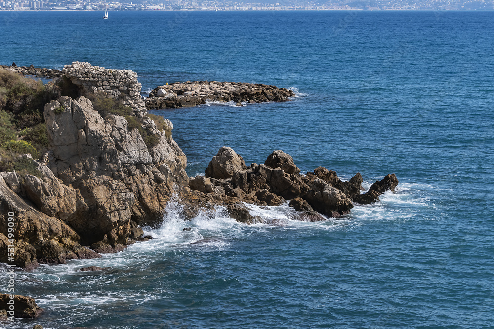 Beautiful Mediterranean coastline under blue sky in Antibes - city on French Riviera between Cannes and Nice.