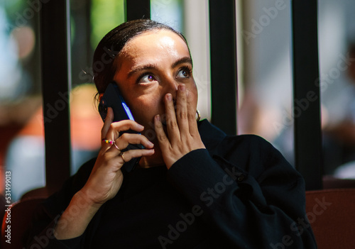 woman on the phone suprised  photo