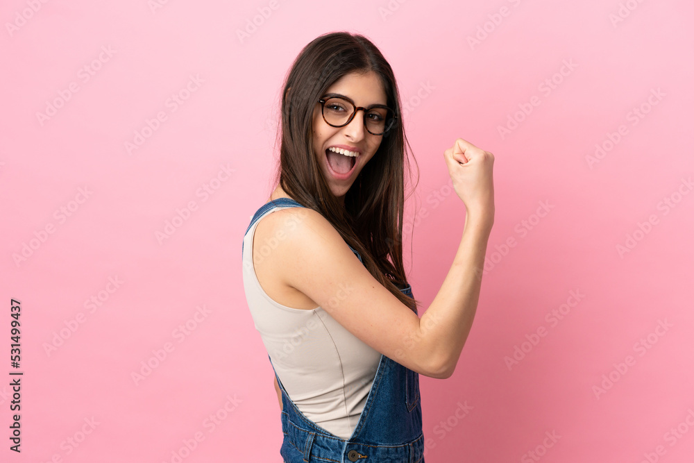 Young caucasian woman isolated on pink background celebrating a victory Young caucasian woman isolated on pink background celebrating a victory