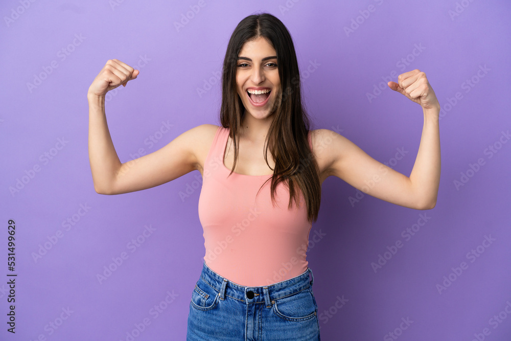 Young caucasian woman isolated on purple background doing strong gesture Young caucasian woman isolated on purple background doing strong gesture