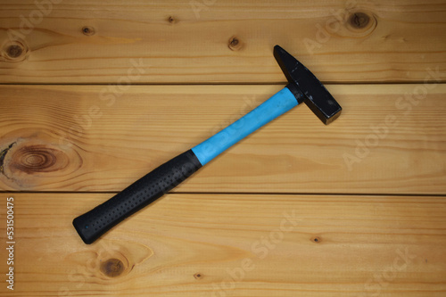 hammer for hammering nails on a wooden background. a repair tool.