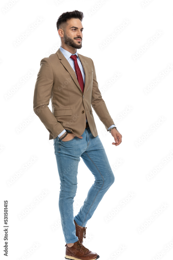 attractive stylish man with hand in pocket looking away and smiling attractive stylish man with hand in pocket looking away and smiling