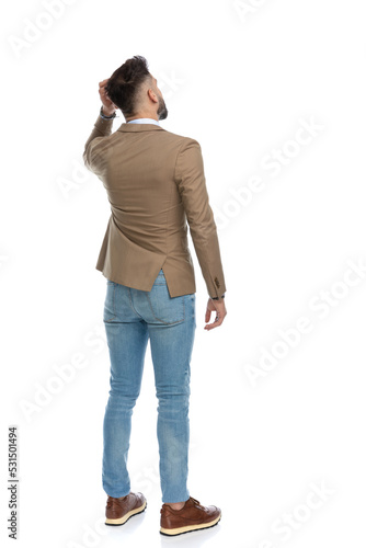 stylish smart casual guy with hand up adjusting hair