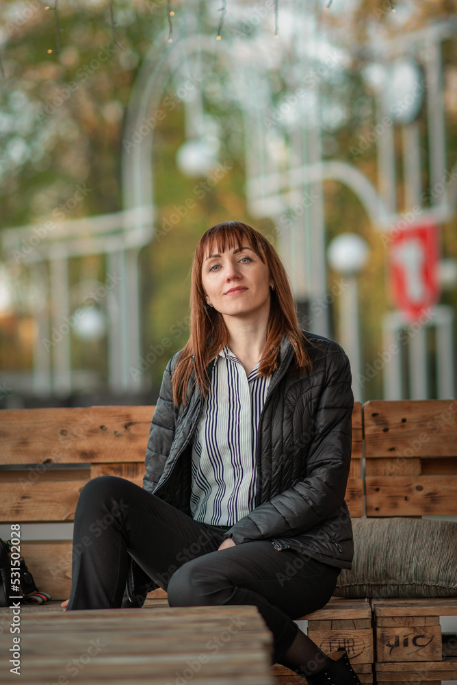 Portrait of a young beautiful red-haired girl in a spring park. There is artistic noise. Portrait of a young beautiful red-haired girl in a spring park. There is artistic noise.