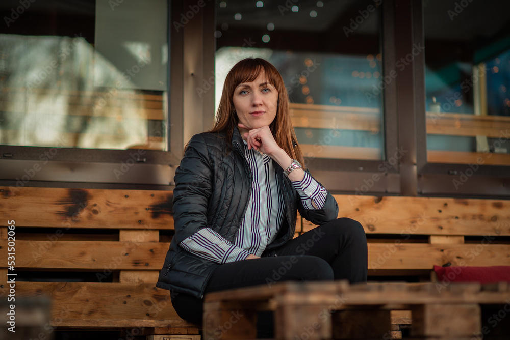 Portrait of a young beautiful red-haired girl in a spring park. There is artistic noise. Portrait of a young beautiful red-haired girl in a spring park. There is artistic noise.