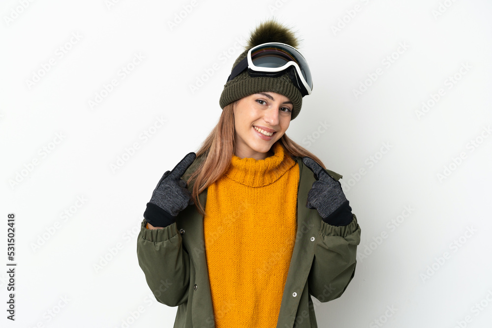 Skier caucasian woman with snowboarding glasses isolated on white background giving a thumbs up gesture Skier caucasian woman with snowboarding glasses isolated on white background giving a thumbs up gesture
