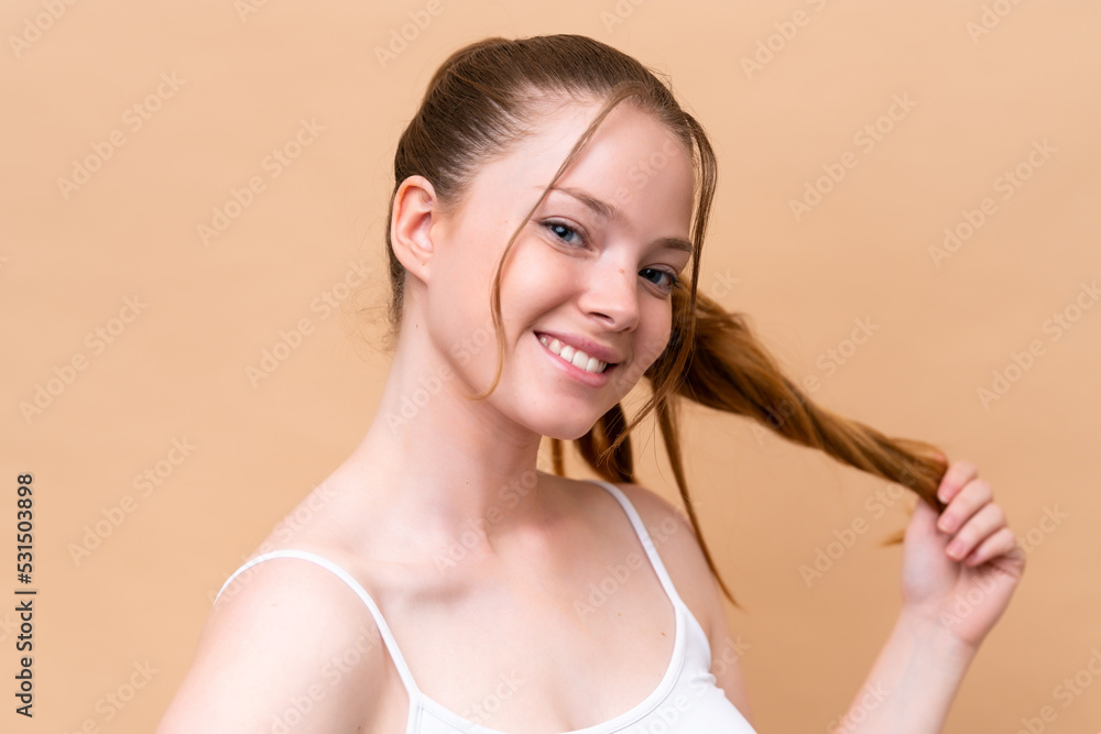 Young caucasian girl isolated on beige background with happy expression. Close up portrait Young caucasian girl isolated on beige background with happy expression. Close up portrait