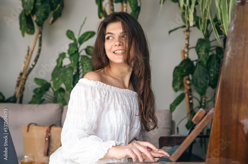 A beautiful young woman plays the old wooden piano. © puhimec