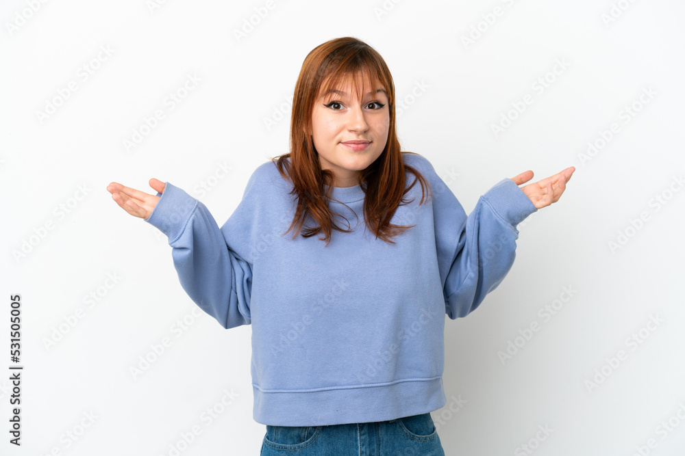 Redhead girl isolated on white background having doubts while raising hands Redhead girl isolated on white background having doubts while raising hands
