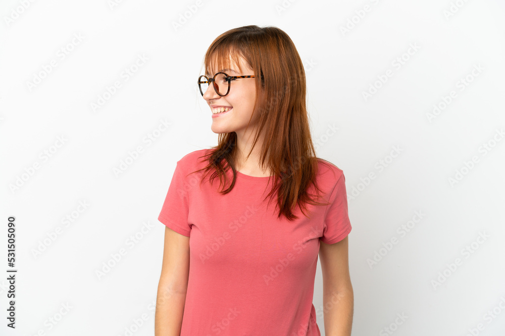 Redhead girl isolated on white background looking side Redhead girl isolated on white background looking side