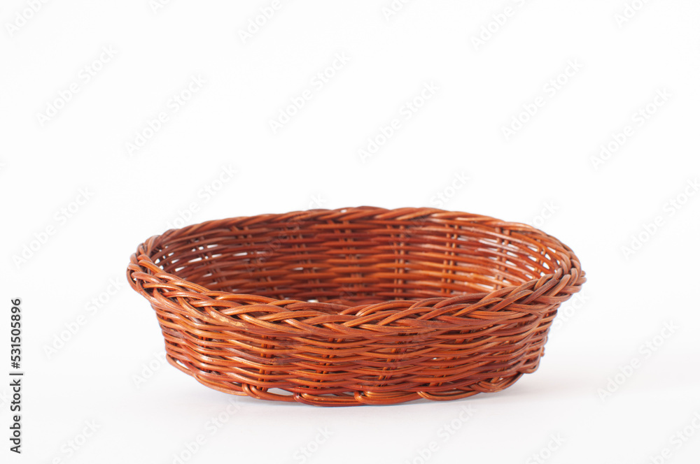 Profile view of vintage weave wicker basket with shallow depth of field on front. Isolated on white background.