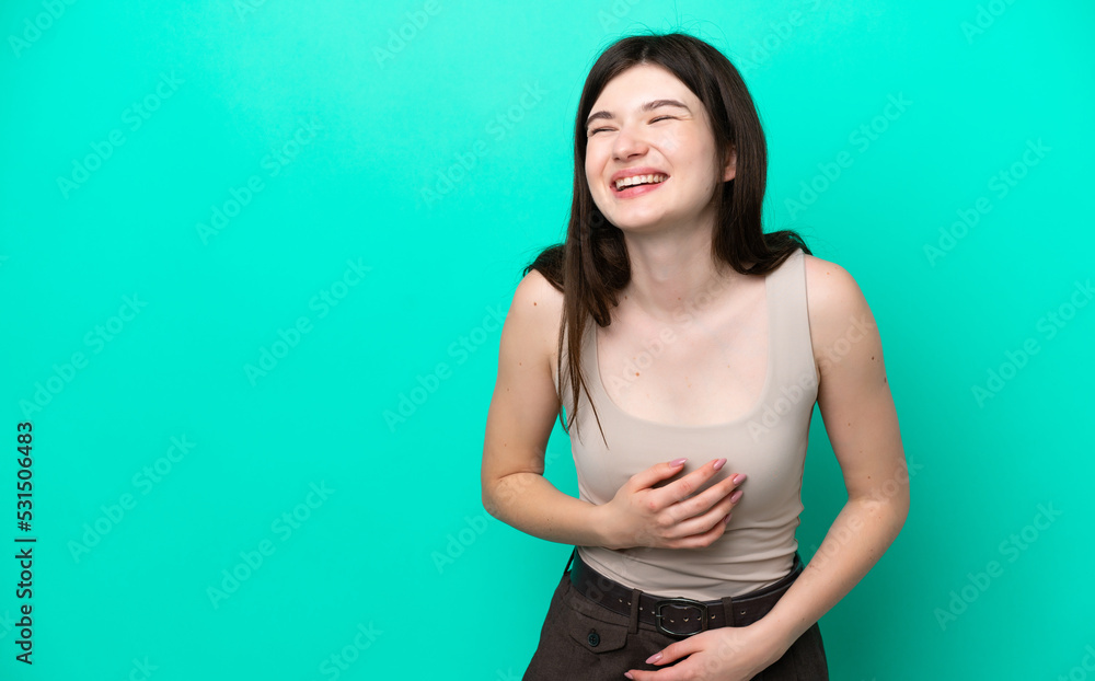 Young Russian woman isolated on green background smiling a lot Young Russian woman isolated on green background smiling a lot