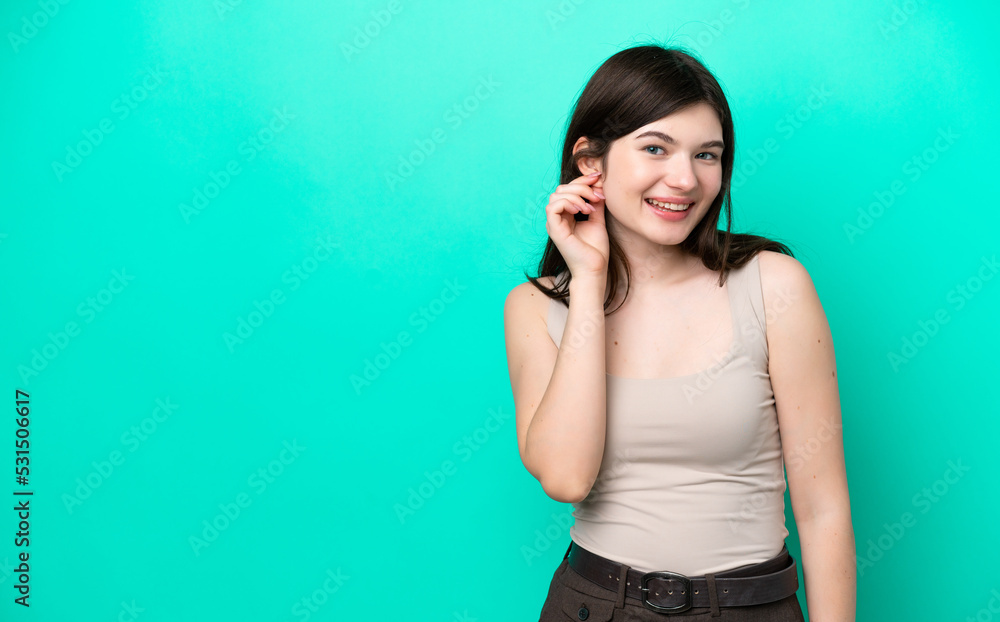Fototapeta premium Young Russian woman isolated on green background laughing