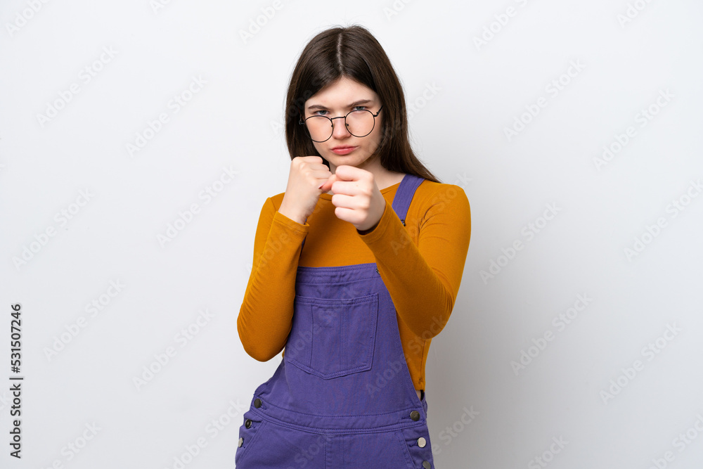 Young Russian woman isolated on blue background with fighting gesture Young Russian woman isolated on blue background with fighting gesture