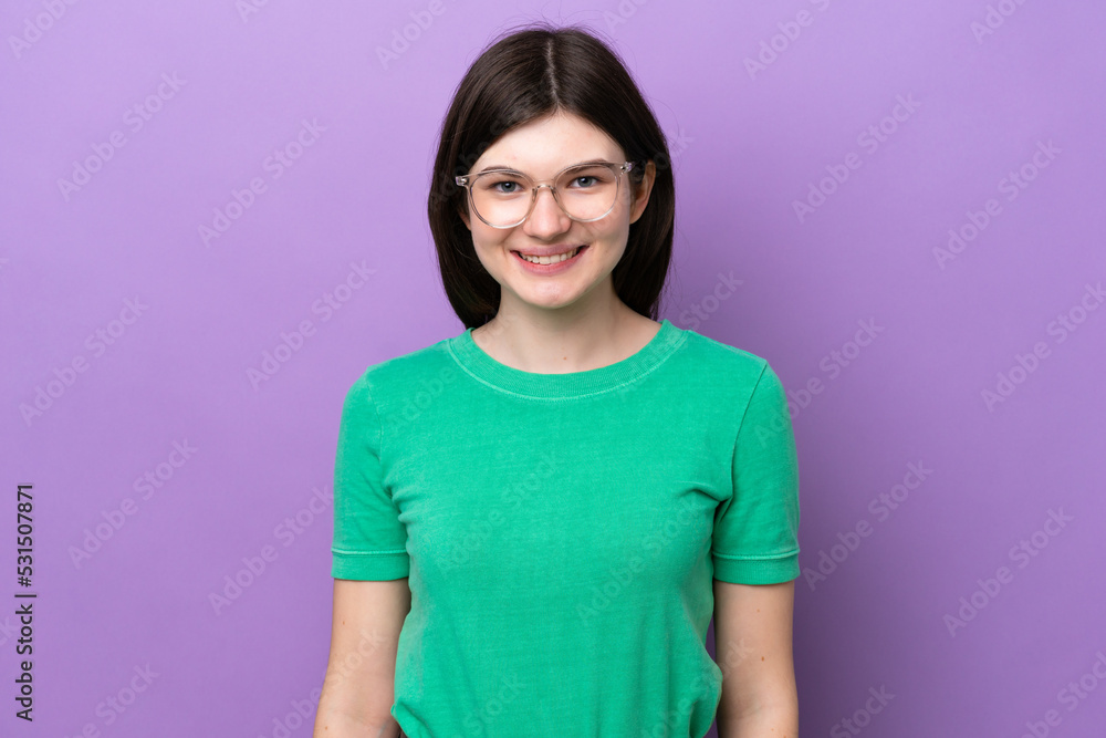 Fototapeta premium Young pretty Russian woman isolated on purple background With glasses with happy expression