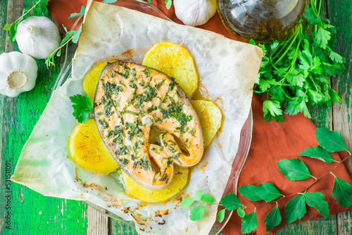 Baked salmon steak with potatoes and parsley