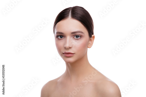 Beautiful young woman with clean fresh skin on face . Girl facial treatment . Cosmetology , beauty and spa photo