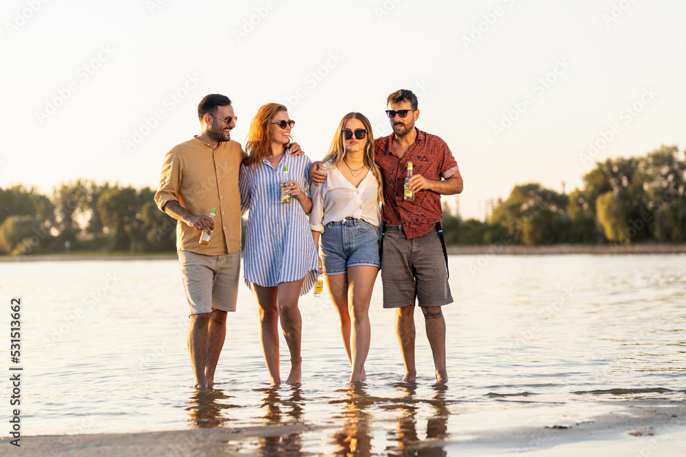 Group of friends on river, drinking beer Laughing and good mood